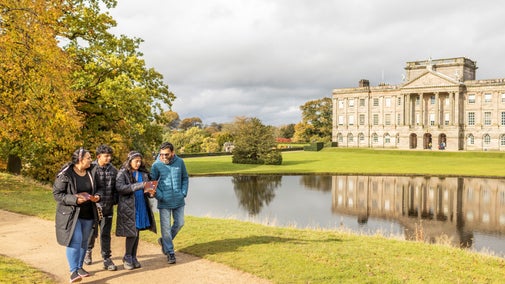 Visitors exploring the garden on a family trail at Lyme, Cheshire